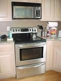 Frigidaire Gallery series electric stove with cooktop, convection over, warming drawer and center bridge element for keeping food warm