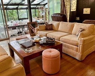 One of two cream upholstered sofas, coffee table and storage stools.  Sofas sold. 