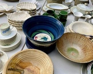 Tables loaded with pottery and fine china.