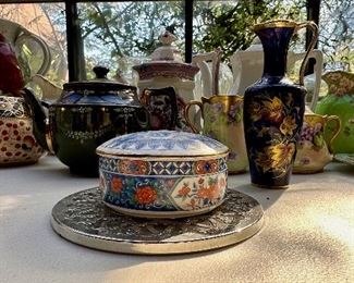 Various tea pots and Tiffany trinket box.  Tiffany trinket box sold. 