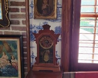 Antique clock and framed colored prints