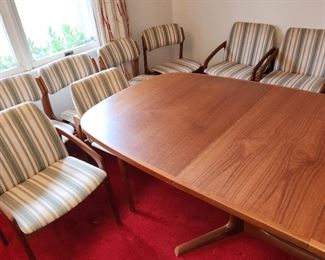 Mid Century Modern teak dining room set by Bernhard Pedersen & Sons. Table comes with 8 chairs 4 with arms) and pads