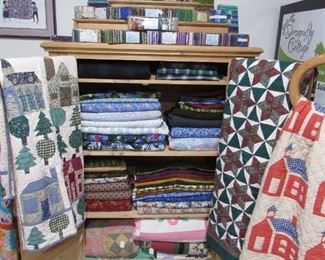 Quilts, cotton flannels, batik packs and quilts.  Also, a great fabric or quilting unfinished pine cupboard. Super charming!