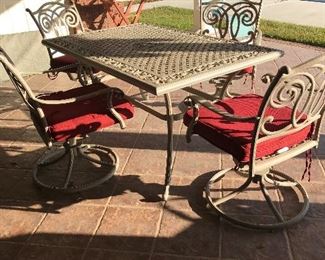 Cast table & 4 swivel chairs with cushions
