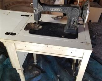 Vintage electric white sewing machine in cabinet