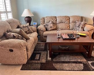 Rocking love seat and couch with sleeper sofa. Brown cloth. 