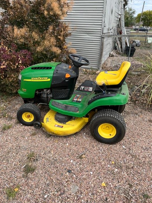 John Deere riding lawn mower. Comes with a pull behind trailer, not pictured.