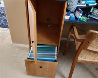 Desk has an attached cupboard and file cabinet