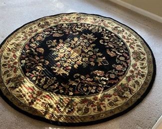#21 round machine rug black and burgundy 70 round $75