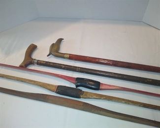Vintage hunting bows and walking sticks