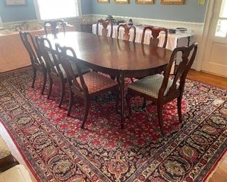 Solid mahogany Henkel Harris dining room table with 12 Queen Anne style chairs, room size Persian rug.