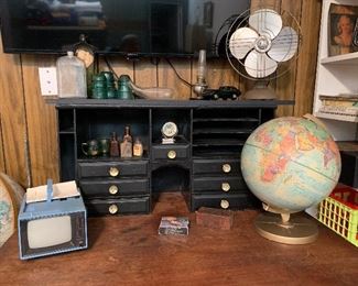 Lots of tchotchkes including globes, vintage electronics & antique apothecary bottles