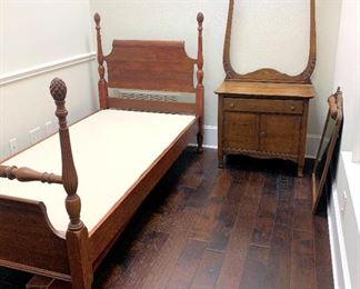 One of two twin size antique poster beds