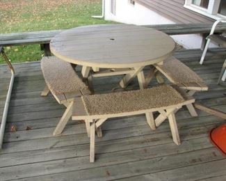 round wooden table and benches