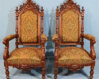143 - Pair of walnut Victorian fireside chairs, heavily carved with head and faces, 4 ft. 4 in. T, 26 in. W, 23 in. D.