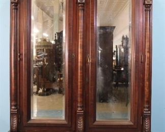  174 - Walnut Victorian wardrobe with birdseye interior, bevel mirror and elaborate shell carving, 92 in. T, 58 in. W, 23 in . D.