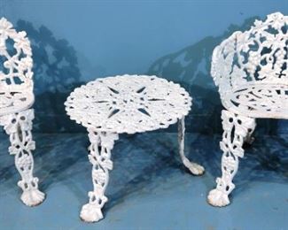 293 - 3 piece set of cast iron garden furniture, 2 chairs and 1 table, 26 in. T, 22 in. W, 12 in. D.