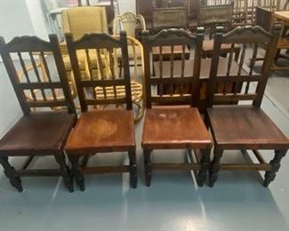 4 wood and leather chairs.