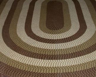 Large oval braided rug in beige tones