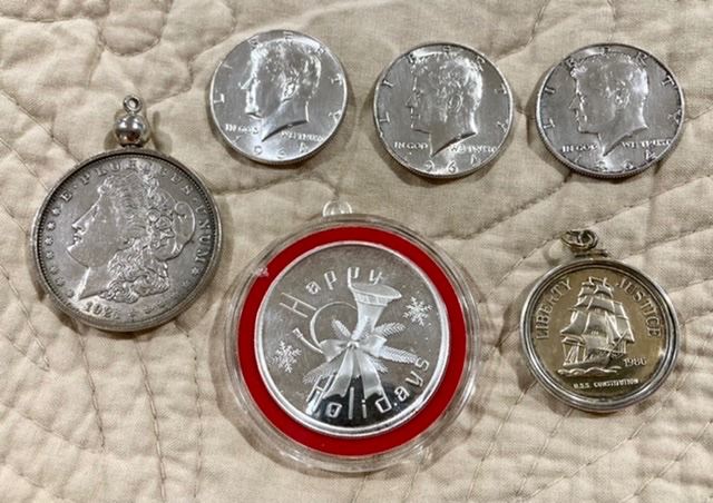 1921 silver dollar, .999 Happy Holidays troy ounce coin, .999 liberty half dollar, 3 1964 Kennedy half dollars (front view)