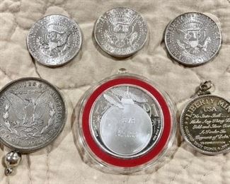 1921 silver dollar, .999 Happy Holidays troy ounce coin, .999 liberty half dollar, 3 1964 Kennedy half dollars (back view)
