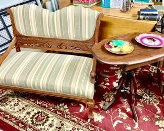 Antique wooden upholstered settee, vintage side table, porcelain plates