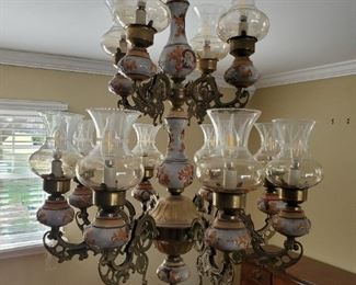 Chandelier has beautiful brass swirls with intricate designs. Hand painted ceramic bulb holders. Hand blown glass goblets. $250
