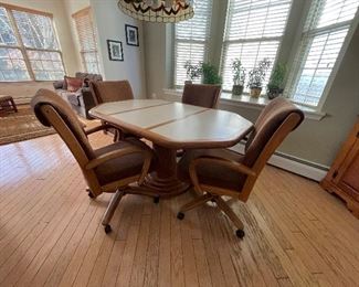 Wood and Formica Pedestal Kitchen Table and 4 Rolling Chairs 