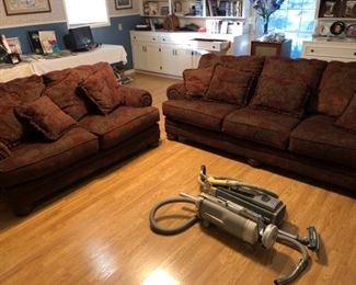 Big, comfy sofa and love seat set, and a pair of cannister vacuums