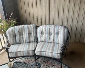 Front gate wrought iron patio furniture newly covered in sunbrella fabric with custom covers. Includes sofa, two chairs and a half, pottery barn coffee table and rug. $2500, paid $1800 just for sunbrella fabric