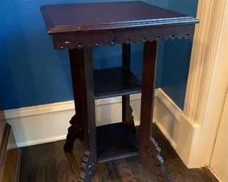 Late Victorian side table with two shelves, sturdy and beautifully decorated.