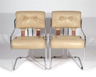 Lot 62  |  PAIR GUIDO FALESCHINI "TUCROMA" ARMCHAIRS  |  Mid-20th century, taupe leather tufted seats and backrests joined with tanned brown strap supports suspended from a chrome tubular steel frame
h. 33 w. 21-1/2 d. 25 in.