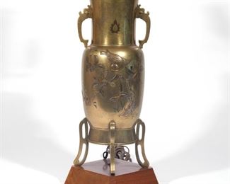 Lot 80 |  MEIJI JAPANESE MIXED METAL VASE  |  Mixed metal footed vase with double handles, decorated with flowers, butterflies, and birds
h. 25 w. 6-3/4 in.