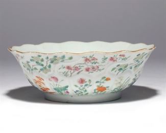 Lot 84 |  CHINESE FAMILLE ROSE PORCELAIN BOWL  |   Jiaqing marks and of the period (1796-1820), of lobed "chrysanthemum" shape, decorated throughout with various flowers, the interior with a medallion of a ruyi scepter tied with a bow and pumpkins among foliage; on a carved wood stand
h. 2-1/2 dia. 7-1/4 in. (bowl)
overall: h. 3-3/4 in. (on stand)