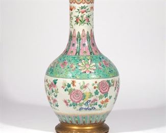 Lot 89  |  CHINESE FAMILLE ROSE PORCELAIN VASE  |  Decorated with insects among flowering branches, with bats around the top rim, with brass base (affixed)
h. 17-1/4 dia. 10 in. (diameter)
overall: h. 28 in. (over harp)