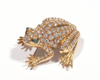 Lot 99  |  DIAMOND, EMERALD, & 18K GOLD FROG BROOCH  |  Designed as a frog encrusted with diamonds and having two emerald cabochons as the eyes, with fineness mark on the foot; 17.3g
h. 1-3/8 w. 1-1/2 in.