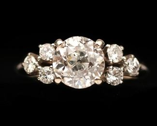 Lot 104  |  1.75CT OLD EUROPEAN CUT DIAMOND ENGAGEMENT RING  |  Designed as a very deep prong-set approx. 1.75ct Old European Brilliant cut diamond flanked by six .05ct round brilliant diamonds in a 14k white gold band; ring size (w/o resizing buttons) 6-1/4, total weight 3.4g Accompanied by GIA Report No. 5172825738 dated August 24, 2016 describing the diamond as a 1.75ct Old European Brilliant cut (7.22x7.41x5.19mm), K color, I2 clarity, very good polish, fair symmetry, and no fluorescence