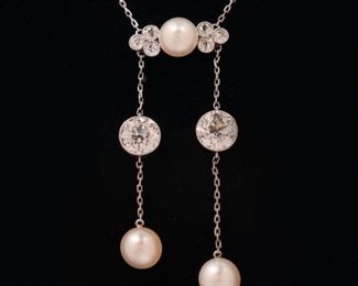 Lot 105  |  ANTIQUE DIAMOND PENDANT NECKLACE  |  Designed as a fine link chain joined by a horizontal gallery mounting a central round 7.2mm pearl flanked by groups of three 0.7ct full cut diamonds, the gallery suspending two chains, each with an old European cut diamond and a pearl; left diamond approximately 1.41 ct [6.90 - 7.05 x 4.60 mm], SI1, G-H color, no fluorescence; pearl 7.4 mm; right diamond approximately 1.38 ct [6.80 - 6.95 x 4.60 mm], SI1, G-H color, no fluorescence; pearl 7.3 mm; In a J. E. Caldwell, Philadelphia Jewelry Box l. 16 in., 6.8g, total diamond weight approximately 6.99cttw