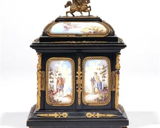 Lot 125  |  VIENNESE ENAMEL & EBONY JEWELRY BOX  |  19th century, having two doors opening to reveal two drawers, decorated with numerous enamel panels on all sides, inside the doors, and on the drawer fronts, showing scenes with allegorical figures and landscapes, all with ormolu surrounds, with figural ormolu column supports and a cavalry rider finial
h. 6 w. 4-3/8 d. 3-1/2 in.             