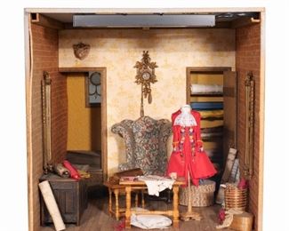 Lot 129  |  LE CHATEAU INTERIORS MINIATURE DISPLAY  |  Jeffrey G. Gueno and Frank L. Hanley, illuminated miniature display of a tailor's workshop, the interior decorated with a miniature wingchair, work table, embroidered coat, mirrors, wall clock, and with other details, having a removable front panel with glass paned window in a stone surround; signed and dated on verso, "Le Chateau Interiors / 1993 / F. Hanley - J. Gueno"
h. 10-1/4 w. 10-1/4 d. 12 in.