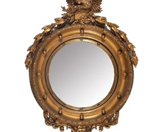 Lot 132  |  LATE 19TH CENTURY FEDERAL-STYLE COMPOSITION MIRROR  |  Convex mirror in a gilt round frame crested by an eagle, with scrolling acanthus
h. 36 w. 27 in.