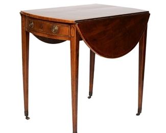 Lot 144  |  GEORGE III MAHOGANY INLAID PEMBROKE TABLE  |  Having bowed sides over single drawer, oval inlaid rosettes in contrasting woods at knees, square tapering legs on castors
h. 28 w. 19 d. 30 in.
