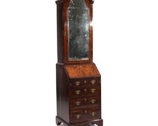 Lot 145  |  GEORGE I WALNUT BUREAU-CABINET OF SMALL SIZE  |  Having a bonnet top over a full length arched beveled mirrored door, the lower section with slant lid opening to fitted interior over four full-width drawers, on bracket base, burl walnut with pine and oak as secondary woods
h. 74 w. 20-1/2 d. 17-1/2 in.