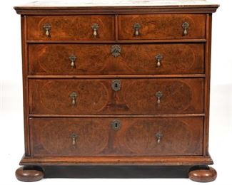 Lot 146  |  WILLIAM & MARY OYSTER VENEER CHEST OF DRAWERS  |  18th century or earlier, the top surface with inlaid decoration, having two half drawers over three graduated full-width drawers, with figural pulls
h. 34-1/2 w. 39 d. 23-1/4 in.
