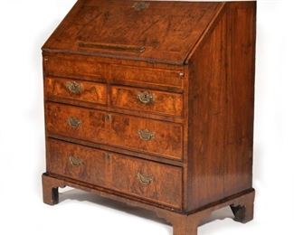 Lot 148  |  GEORGE I INLAID WALNUT SLANT-LID DESK  |  Drop-front desk with inset leather writing surface before pigeon holes and fitted stepped drawers, over two half-width drawers over two full-width graduated drawers
h. 43 w. 40 d. 21-1/2 in.