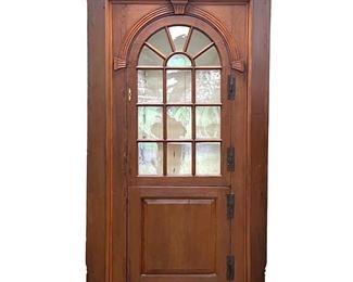 Lot 155  |  18TH CENTURY AMERICAN BARREL BACK CORNER CUPBOARD  |  Arched glazed door, over a lower paneled cabinet door interior with fixed shelves, white painted interior
h. 83-1/2 w. 55 d. 22-1/2 in.
