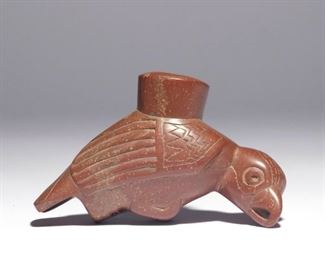 Lot 175  |  NATIVE AMERICAN CARVED BIRD PIPE BOWL  |  The red Catlinite pipe bowl in the form of a bird with its feet tucked under its breast, inscribed with place of discovery "Boyle Co., KY" and an inventory number (or year of discovery?) "1900", Coe inventory number 5007
h. 2-7/8 w. 4-1/2 d. 1-5/8 in.