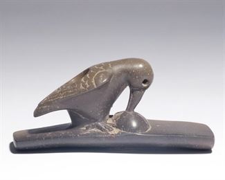 Lot 181  |  NATIVE AMERICAN EFFIGY PIPE - BIRD  |  Hopewell Culture, Ohio, a platform pipe with a bird pecking out the eye of a human face, carved out of grey pipestone that fades to black, label indicating place of discovery as Perry Co., Ohio, Coe inventory 5040
h. 1-7/8 w. 4 d. 1-3/8 in.