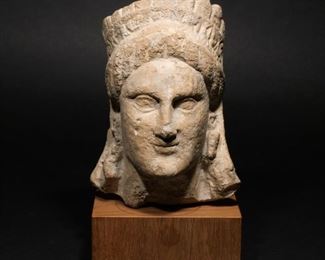 Lot 185  |  CYPRIOT LIMESTONE HEAD OF A GODDESS  |  Circa 3rd-2nd century, B.C., the head turned slightly to the left and wearing large pyramidal earrings, a high crown composed of a band of rosettes surmounted by palmettes, old acquisition number on verso, with wood stand
Published: Mary B. Comstock & Cornelius C. Vermeule, Sculpture in Stone: The Greek, Roman, and Etruscan Collections of the Museum of Fine Arts, Boston, 1976, #447 (illustrated) Exhibited: Albany, University Art Gallery, State University of New York at Albany: "Sculpture of Cyprus", Oct. 13 - Nov. 17, 1974, No. 2 (illustrated)
