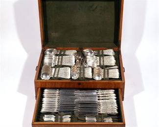 Lot 197  |  WHITING "COLONIAL B ENGRAVED" STERLING FLATWARE  |  A fine example of engraved decorated Whiting's sterling silver flatware comprising; 12 dinner forks, 12 luncheon forks, 12 salad forks, 12 cocktail forks, 12 teaspoons, 12 cream soup spoons, 12 bullion spoons, 12 demitasse spoons, 12 steel-bladed dinner knives, 12 steel-bladed luncheon knives, 11 flat handled butter spreaders, plus serving items: 6 serving spoons, a fish fork, a cold meat fork, two ladles, a vegetable spoon, a silver bladed cake knife, a dinner carving set (2pc), a luncheon carving set (2pc), steel tine fork, sharpening rod, and a pickle fork, all monogrammed; complete with fitted brass-bound white oak storage case with dedication dated March 1909; 136 ozt total weighable silver, 150 total pieces